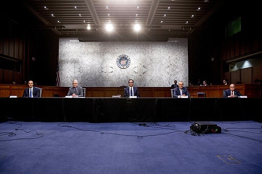 From left, Labor Secretary Eugene Scalia, Senate Majority Leader Mitch McConnell of Ky., Treasury Secretary Steven Mnuchin, Senate Minority Leader Sen. Chuck Schumer of N.Y., and White House chief economic adviser Larry Kudlow attend a a meeting to discuss the coronavirus relief bill on Capitol Hill, Friday, March 20, 2020, in Washington. (AP Photo/Andrew Harnik)