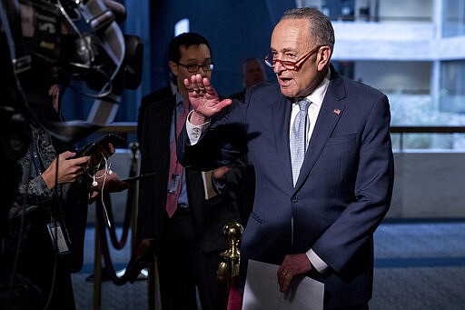 Senate Minority Leader Sen. Chuck Schumer of N.Y., speaks to reporters as he arrives for a meeting to discuss the coronavirus relief bill on Capitol Hill, Friday, March 20, 2020, in Washington. (AP Photo/Andrew Harnik)