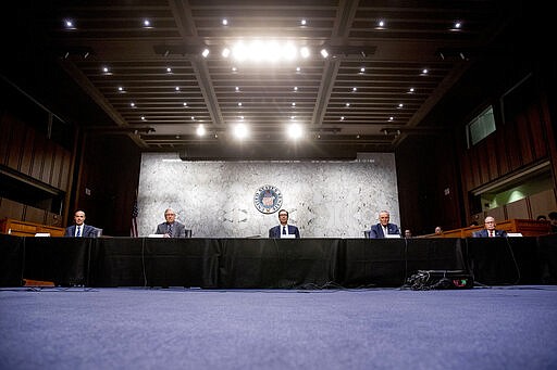 From left, Labor Secretary Eugene Scalia, Senate Majority Leader Mitch McConnell of Ky., Treasury Secretary Steven Mnuchin, Senate Minority Leader Sen. Chuck Schumer of N.Y., and White House chief economic adviser Larry Kudlow attend a a meeting to discuss the coronavirus relief bill on Capitol Hill, Friday, March 20, 2020, in Washington. (AP Photo/Andrew Harnik)