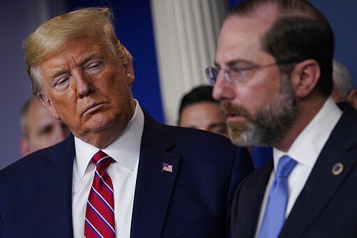 President Donald Trump listens as Department of Health and Human Services Secretary Alex Azar speaks during a coronavirus task force briefing at the White House, Friday, March 20, 2020, in Washington. (AP Photo/Evan Vucci)