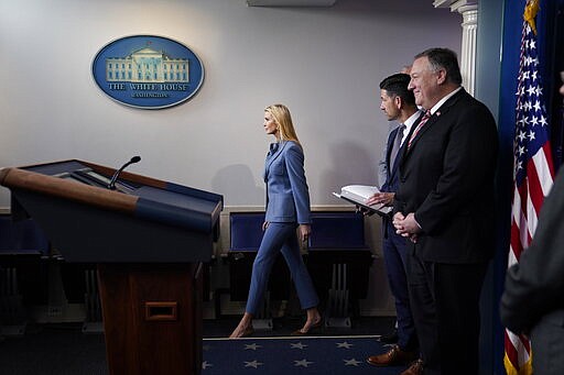 Ivanka Trump, the daughter and assistant to President Donald Trump, center arrives to attend a coronavirus task force briefing at the White House, Friday, March 20, 2020, in Washington. (AP Photo/Evan Vucci)