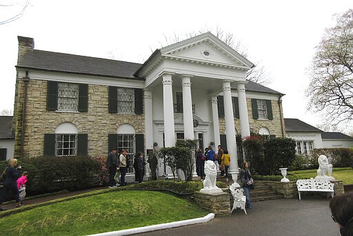 FILE - In this March 13, 2017, file photo, visitors get ready to tour Graceland in Memphis, Tenn. Elvis Presley's Graceland is closing in response to the coronavirus outbreak, Friday, March 20, 2020.(AP Photo/Beth J. Harpaz)