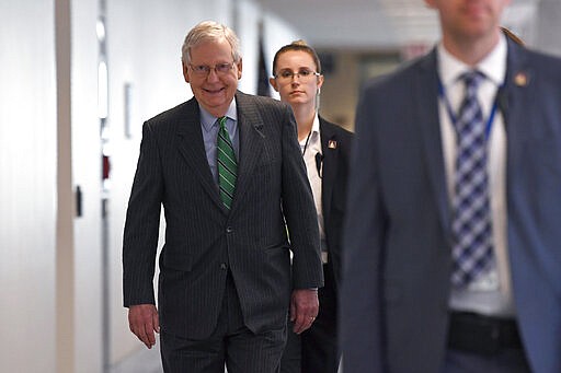 Senate Majority Leader Mitch McConnell of Ky., walk to attend a Republican policy lunch on Capitol Hill in Washington, Thursday, March 19, 2020. (AP Photo/Susan Walsh)