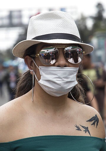 A spectator attends the Vive Latino music festival in Mexico City, Sunday, March 15, 2020. The two-day rock festival is one of the most important and longest running of Mexico. (AP Photo/Christian Palma)