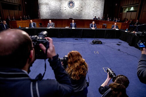 From left, Sen. John Thune, R-S.D., Labor Secretary Eugene Scalia, Senate Majority Leader Mitch McConnell of Ky., Treasury Secretary Steven Mnuchin, Senate Minority Leader Sen. Chuck Schumer of N.Y., White House chief economic adviser Larry Kudlow, and others, attend a a meeting to discuss the coronavirus relief bill on Capitol Hill, Friday, March 20, 2020, in Washington. (AP Photo/Andrew Harnik)