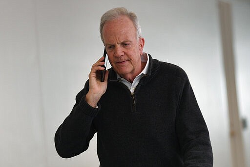 Sen. Jerry Moran, R-Kan., talks on the phone as he heads into a Republican policy lunch on Capitol Hill in Washington, Thursday, March 19, 2020. (AP Photo/Susan Walsh)