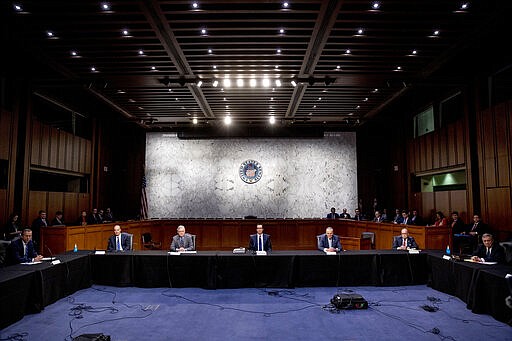 From left, Sen. John Thune, R-S.D., Labor Secretary Eugene Scalia, Senate Majority Leader Mitch McConnell of Ky., Treasury Secretary Steven Mnuchin, Senate Minority Leader Sen. Chuck Schumer of N.Y., White House chief economic adviser Larry Kudlow, Sen. Richard Durbin, D-Ill., and others, attend a a meeting to discuss the coronavirus relief bill on Capitol Hill, Friday, March 20, 2020, in Washington. (AP Photo/Andrew Harnik)