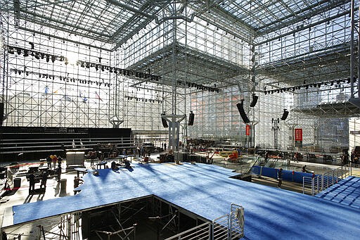 FILE- In this Nov. 4, 2016 file photo, a blue carpeted stage for Democratic presidential candidate Hillary Clinton's election night venue is being prepared inside the Jacob K. Javits Convention Center in New York. On Saturday, March 21, 2020, New York Gov. Andrew Cuomo said the state is looking to see if the venue, normally home to the auto show and other big events, could be suitable for 1,000 requested field hospital beds that would be supplied by FEMA in a &quot;tent configuration&quot; with equipment and staff. (AP Photo/Mark Lennihan, File)