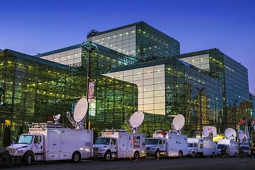 FILE - In this Nov. 6, 2016 file photo, television satellite trucks line up outside the Jacob K. Javits Convention Center in New York as preparations continued inside for Democratic presidential nominee Hillary Clinton's election night rally. On Saturday, March 21, 2020, New York Gov. Andrew Cuomo said the state is looking to see if the venue, normally home to the auto show and other big events, could be suitable for 1,000 requested field hospital beds that would be supplied by FEMA in a &quot;tent configuration&quot; with equipment and staff. (AP Photo/J. David Ake, File)