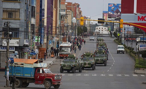 Military armored vehicles patrol the streets during a quarantine in El Alto, Bolivia, Friday, March 20, 2020. Authorities have decreed a quarantine from 5pm to 5am in an attempt to stop the spread of the new coronavirus. The vast majority of people recover from the COVID-19 disease. (AP Photo/Juan Karita)