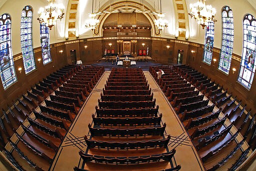 Rodef Shalom Rabbi Aaron Bisno, center, delivers his sermon to an empty synagogue, during an Erev Shabbat service that is being streamed live on Facebook, Friday, March 20, 2020 in Pittsburgh. All events have been suspended at the synagogue until April 16, to help mitigate the spread of the COVID-19 virus. (AP Photo/Gene J. Puskar)