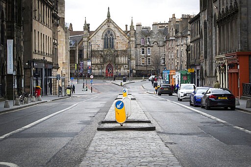 A view of a virtually empty George IV Bridge, in Edinburgh, Scotland, Saturday March 21, 2020. For some people the COVID-19 coronavirus causes mild or moderate symptoms, but for others it causes severe illness. (Jane Barlow/PA via AP)