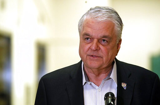 FILE - In this Tuesday, March 17, 2020 file photo Nevada Gov. Steve Sisolak speaks during a news conference at the Sawyer State Building in Las Vegas. Sisolak on Friday, March 20, 2020, followed governors of states including California, New York and Illinois in imposing near-lockdowns on restaurants and other businesses to keep millions of people inside except for essentials and exercise. (Steve Marcus/Las Vegas Sun via AP,File)
