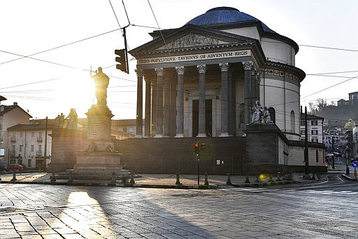 The sun shines behind the Gran Madre di Dio church in Turin, Italy on Saturday, March 21, 2020, during the country-wide lockdown due to the COVID-19 coronavirus. (Fabio Ferrari/LaPresse via AP)