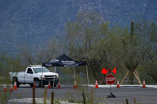 A security checkpoint at the entrance to the Gila River Hotels &amp; Casinos Vee Quiva location shows the property is closed due to the coronavirus Friday, March 20, 2020, in Laveen, Ariz. Native American tribes across the U.S. have been closing their properties, with all casinos in the Phoenix metro area closing down. (AP Photo/Ross D. Franklin)