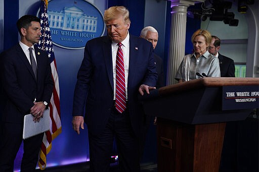 FILE - In this March 20, 2020, file photo President Donald Trump leaves after speaking at a coronavirus task force briefing at the White House in Washington. Trump's political fate may be left up to the sliver of moderates in the middle, who will choose whether to blame him for the coronavirus crisis spiraling on his watch. (AP Photo/Evan Vucci, File)