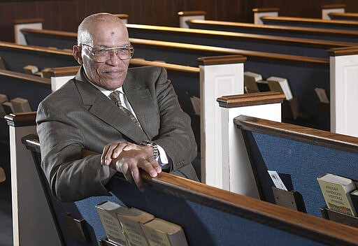 The Rev. Alvin J. Gwynn Sr., of Friendship Baptist Church in Baltimore, sits in his church's sanctuary, Thursday, March 19, 2020. He bucked the cancellation trend by holding services the previous Sunday. But attendance was down by about 50%, and Gwynn said the day&#146;s offering netted about $5,000 compared to a normal intake of about $15,000. &#147;It cuts into our ministry,&#148; he said. &#147;If this keeps up, we can&#146;t fund all our outreach to help other people.&#148; (AP Photo/Steve Ruark)