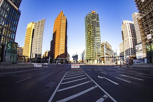 Leipziger Strasse is free of people and cars at Potsdamer Platz in Berlin at Saturday morning, March 21, 2020. The senate announces further measures to stop the spread of the corona virus in Berlin. For most people, the new coronavirus causes only mild or moderate symptoms. For some it can cause more severe illness. (Paul Zinken/dpa via AP)