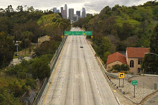 Extremely light traffic moves along the 110 Harbor Freeway toward downtown mid afternoon, Friday, March 20, 2020, in Los Angeles. Traffic would normally be bumper-to-bumper during this time of day on a Friday. California Gov. Gavin Newsom is ordering the state's 40 million residents to stay at home indefinitely. His order restricts non-essential movements to control the spread of the coronavirus that threatens to overwhelm the state's medical system. He called up 500 National Guard troops Thursday to help with distributing food. (AP Photo/Mark J. Terrill)