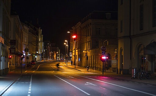 Luitpold Street in Bamberg, Germany,  is seen shortly after the initial restriction imposed due to the spread of the coronavirus came into force, early Saturday, March 21, 2020. A curfew went into effect for Bavaria. Leaving one's own home is now only allowed if there are good reasons. (Nicolas Armer/dpa via AP)