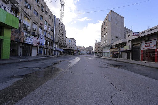 The streets of the Jordanian Capital are seen empty after the start of a nationwide curfew, amid concerns over the coronavirus pandemic, in Amman, Jordan ,Saturday , March 21, 2020.  Air raid sirens have echoed across Jordan's capital to mark the start of a three-day curfew. It's the latest mass lockdown in the Middle East aimed at containing the coronavirus (AP Photo/Raad Adayleh)