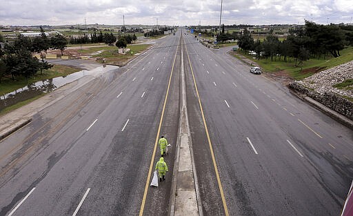 The streets of the Jordanian Capital are seen empty after the start of a nationwide curfew, amid concerns over the coronavirus pandemic, in Amman, Jordan, Saturday, March 21, 2020. Air raid sirens have echoed across Jordan's capital to mark the start of a three-day curfew. It's the latest mass lockdown in the Middle East aimed at containing the coronavirus (AP Photo/Raad Adayleh)