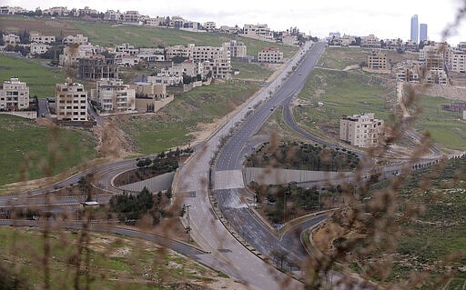 The streets of the Jordanian Capital are seen empty after the start of a nationwide curfew, amid concerns over the coronavirus pandemic, in Amman, Jordan,Saturday, March 21, 2020.  Air raid sirens have echoed across Jordan's capital to mark the start of a three-day curfew. It's the latest mass lockdown in the Middle East aimed at containing the coronavirus (AP Photo/Raad Adayleh)