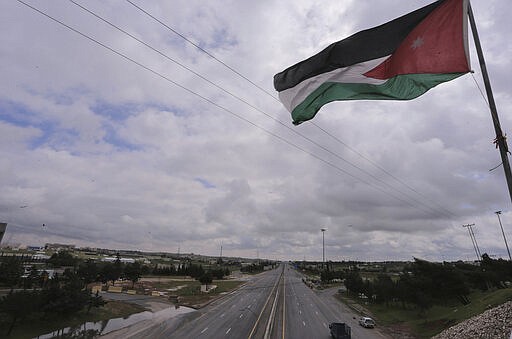 The streets of the Jordanian Capital are seen empty after the start of a nationwide curfew, amid concerns over the coronavirus pandemic, in Amman, Jordan,Saturday, March 21, 2020.  Air raid sirens have echoed across Jordan's capital to mark the start of a three-day curfew. It's the latest mass lockdown in the Middle East aimed at containing the coronavirus.  (AP Photo/Raad Adayleh)