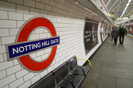 An elderly couple walk along the platform at Notting Hill Gate station in London, Saturday, March 21, 2020. For most people the new coronavirus causes mild or moderate symptoms, but for some, especially older adults and people with existing health problems, it can cause more severe illness, including pneumonia. (AP Photo/Kirsty Wigglesworth)