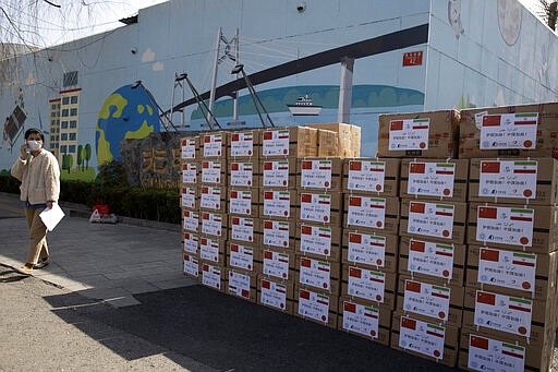 A worker from a charity foundation prepares boxes of disinfectant tablets to be donated to Iran in Beijing on Monday, March 16, 2020. China, which didn't have enough protective equipment for its medical workers a few weeks ago, is now donating supplies to Italy, Iran, South Korea and other affected places. (AP Photo/Ng Han Guan)