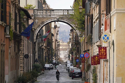 A view of an empty street, in Rome, Saturday, March 21, 2020. Mayors of many towns in Italy are asking for ever more stringent measures on citizens' movements to help contain the surging infections of the coronavirus. For most people, the new coronavirus causes only mild or moderate symptoms. For some it can cause more severe illness, especially in older adults and people with existing health problems. (AP Photo/Andrew Medichini)