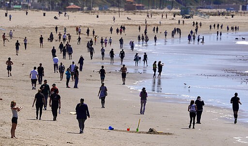 Beachgoers are seen at Venice Beach, Saturday, March 21, 2020, in Los Angeles. Traffic would normally be bumper-to-bumper during this time of day on a Friday. California Gov. Gavin Newsom ordered the state's 40 million residents to stay at home indefinitely. His order restricts non-essential movements to control the spread of the coronavirus that threatens to overwhelm the state's medical system. (AP Photo/Mark J. Terrill)