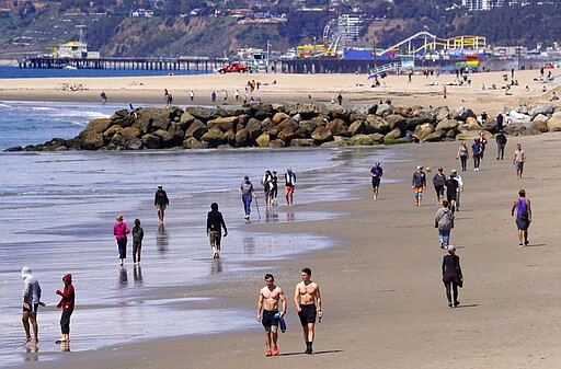 Beachgoers are seen at Venice Beach, Saturday, March 21, 2020, in Los Angeles. Traffic would normally be bumper-to-bumper during this time of day on a Friday. California Gov. Gavin Newsom ordered the state's 40 million residents to stay at home indefinitely. His order restricts non-essential movements to control the spread of the coronavirus that threatens to overwhelm the state's medical system. (AP Photo/Mark J. Terrill)