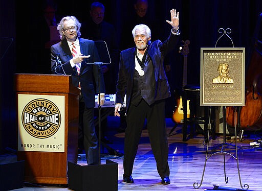 ADDS YEAR - FILE - In this Oct. 27, 2013, file photo, country music star Kenny Rogers thanks the audience at the ceremony for the 2013 inductions into the Country Music Hall of Fame in Nashville, Tenn. Actor-singer Kenny Rogers, the smooth, Grammy-winning balladeer who spanned jazz, folk, country and pop with such hits as &#147;Lucille,&#148; &#147;Lady&#148; and &#147;Islands in the Stream&#148; and embraced his persona as &#147;The Gambler&#148; on record and on TV died Friday night, March 20, 2020. He was 81. (AP Photo/Mark Zaleski, File)