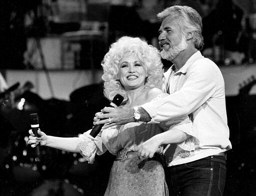 FILE - In this Sept. 27, 1983 file photo, Country Music singers Dolly Parton and Kenny Rogers rehearse a song for their appearance on the TV show &quot;Live... And in Person&quot; in Los Angeles.  Rogers, who embodied &#147;The Gambler&#148; persona and whose musical career spanned jazz, folk, country and pop, has died at 81. A representative says Rogers died at home in Georgia on Friday, March 20, 2020.  (AP Photo/Doug Pizac, File)