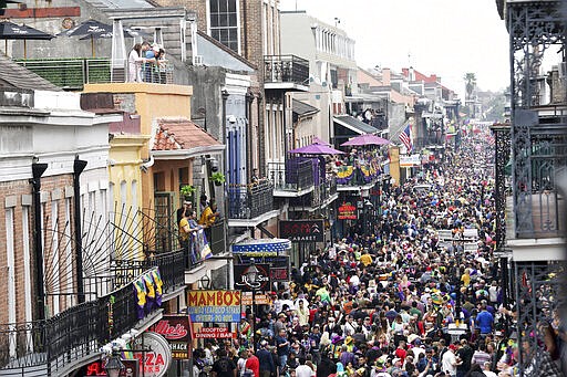 FILE - In this Tuesday, Feb. 25, 2020, file photo, Bourbon Street is a sea of humanity on Mardi Gras day in New Orleans. In the city here, the old saying &#147;Let the good times roll&#148; has given way to a new municipal maxim: &#147;Wash your hands.&#148; A month ago the city was awash in people and steeped in its annual tradition of communal joy &#151; the Mardi Gras season. But now New Orleans has joined those places shutting down bars, eliminating restaurant dining and banning crowds. (AP Photo/Rusty Costanza, File)