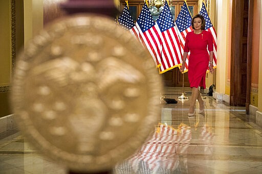 House Speaker Nancy Pelosi of Calif. arrives to read a statement outside her office on Capitol Hill, Monday, March 23, 2020, in Washington. (AP Photo/Andrew Harnik, Pool)