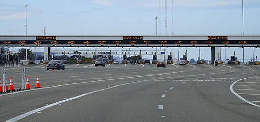 Motorists approach the toll plaza on the eastern span of the San Francisco-Oakland Bay Bridge on Sunday, March 22, 2020, in San Francisco. California Gov. Gavin Newsom has ordered the temporary suspension of cash toll collection at the San Francisco Bay Area's seven state-owned bridges in order to minimize the risk of exposure to the coronavirus. (AP Photo/Ben Margot)