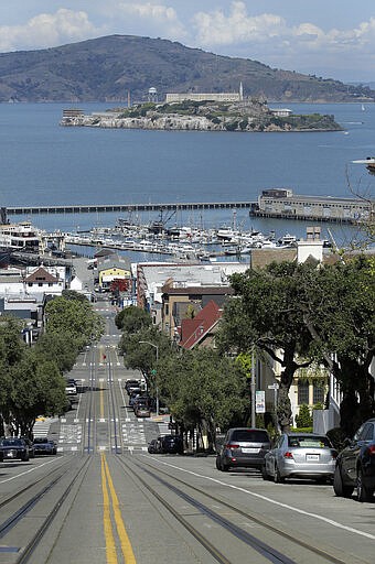 A view down Hyde Street towards a deserted Fisherman's Wharf and Alcatraz Island on Sunday, March 22, 2020, in San Francisco. Some 40 million Californians are coping with their first weekend under a statewide order requiring them to stay at home to help curb the spread of the coronavirus. (AP Photo/Ben Margot)