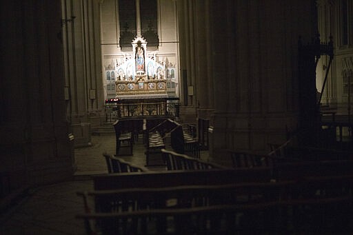 Church benches are taped off at the St. Vincent de Paul church in Marseille, southern France, Saturday, March 21, 2020. As mass gatherings are forbidden due to measures to prevent the spread of COVID- 19, priests are using technology to reach worshippers forced to stay at home. For most people, the new coronavirus causes only mild or moderate symptoms. (AP Photo/Daniel Cole)