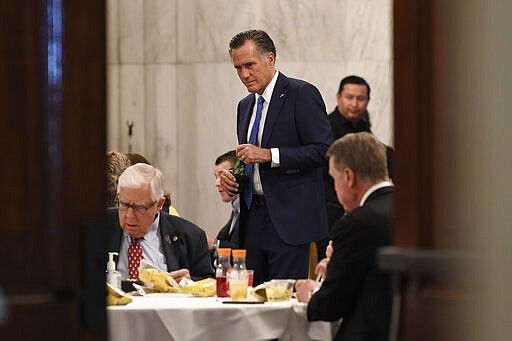 Sen. Mitt Romney, R-Utah, attends a Republican policy lunch on Capitol Hill in Washington, Friday, March 20, 2020, to work on sweeping economic rescue plan amid the pandemic crisis and nationwide shutdown that's hurtling the country toward a likely recession. (AP Photo/Susan Walsh)