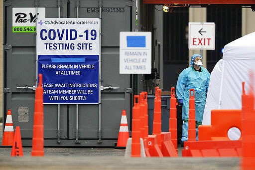 Medical personnel at Advocate Lutheran General Hospital, conduct drive-thru COVID-19 testing in Park Ridge, Ill., Thursday, March 19, 2020. Chicago officials have ordered all people with confirmed cases of COVID-19 or showing symptoms of the disease caused by it to stay indoors. The order issued Thursday formalized previous advice seeking to limit the spread of the coronavirus. (AP Photo/Nam Y. Huh)