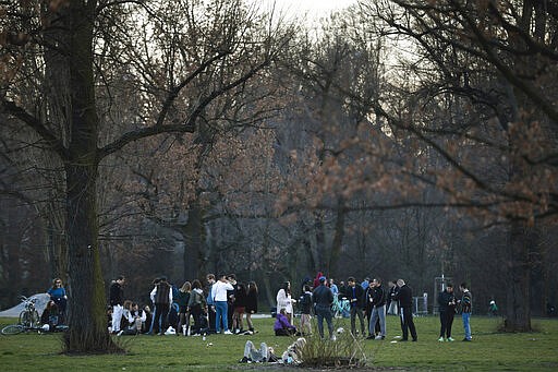 Young people gather in the Volkspark am Friedrichshain in Berlin, Germany, Wednesday, March 18, 2020. The Berlin government has banned all events with more than about 50 people because of the coronavirus outbreak but the parks of the city are still used by a high number of people. For most people, the new coronavirus causes only mild or moderate symptoms, such as fever and cough. For some, especially older adults and people with existing health problems, it can cause more severe illness, including pneumonia. (AP Photo/Markus Schreiber)