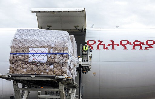 A cargo flight containing over 6 million medical items including face masks, test kits, face shields and protective suits arrives in the capital Addis Ababa, Ethiopia Sunday, March 22, 2020. The supplies arriving from Guangzhou, China for fighting the spread in Africa of the COVID-19 coronavirus were donated by the Jack Ma Foundation and Alibaba Foundation and will be distributed from Ethiopia to countries throughout Africa. (AP Photo/Mulugeta Ayene)