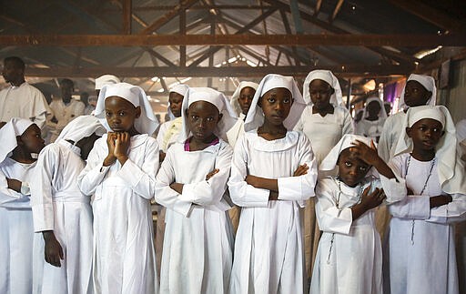 Young Christian faithful of the Legio Maria African Mission attend a Sunday mass service in the Kibera slum of the capital Nairobi, Kenya Sunday, March 22, 2020. In Kenya, the Ministry of Health has banned all public gatherings and meetings in order to limit the spread of the new coronavirus that causes COVID-19 but has permitted normal church services to continue so long as they provide hand sanitizing or washing facilities to attendees. (AP Photo/Brian Inganga)