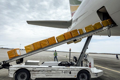 A cargo flight containing over 6 million medical items including face masks, test kits, face shields and protective suits arrives in the capital Addis Ababa, Ethiopia Sunday, March 22, 2020. The supplies arriving from Guangzhou, China for fighting the spread in Africa of the COVID-19 coronavirus were donated by the Jack Ma Foundation and Alibaba Foundation and will be distributed from Ethiopia to countries throughout Africa. (AP Photo/Mulugeta Ayene)