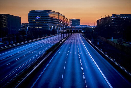 The highway along the airport is empty in Frankfurt, Germany, Sunday, March 22, 2020. Due to the coronavirus the aviation industry expects heavy losses. For most people, the new coronavirus causes only mild or moderate symptoms, such as fever and cough. For some, especially older adults and people with existing health problems, it can cause more severe illness, including pneumonia. (AP Photo/Michael Probst)