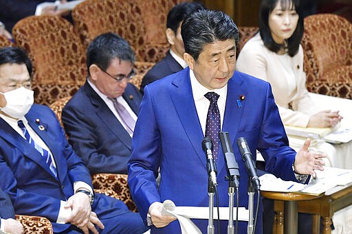Japan&#146;s Prime Minister Shinzo Abe speaks at a parliamentary session in Tokyo Monday, March 23, 2020. Abe said a postponement of Tokyo Olympics would be unavoidable if the games cannot be held in a complete way because of the coronavirus pandemic. (Yoshitaka Sugawara/Kyodo News via AP)