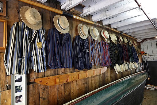 Jackets and hats belonging to punt boat handlers hang on a wall in their sheds on the Avon River in central Christchurch, New Zealand, Monday, March 23, 2020. New Zealand Prime Minister Jacinda Ardern announced Monday that schools and non-essential services across New Zealand will be closed as part of the measures as the government put the country in lockdown to try to stop the spread of coronavirus pandemic. (AP Photo/Mark Baker)