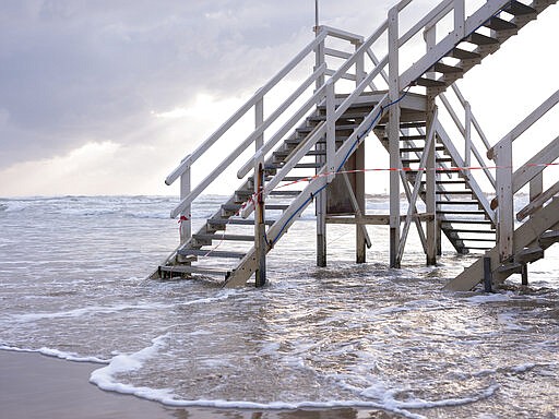 This Thursday, March 19, 2020 photo shows stairway to lifeguard tower at Tel Aviv's beachfront wrapped in tape to prevent public access. Israel has reported a steady increase in confirmed cases despite imposing strict travel bans and quarantine measures more than two weeks ago. Authorities recently ordered the closure of all non-essential businesses and encouraged people to work from home. (AP Photo/Oded Balilty)